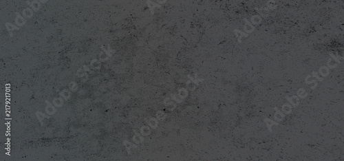 Dark grey concrete or grunge texture background with rough surface details and subtle scratches