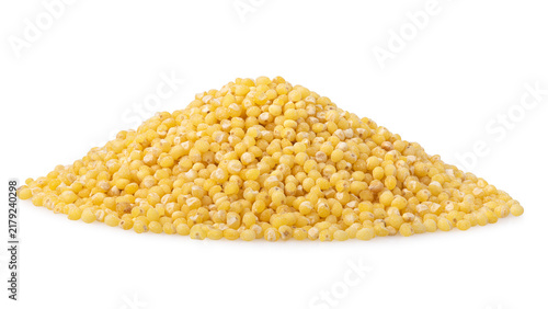 Pile of dry yellow millet groats with scattered grains isolated on white background
