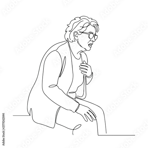 Elderly woman experiencing health issue while sitting down, showing a worried expression and holding her chest.