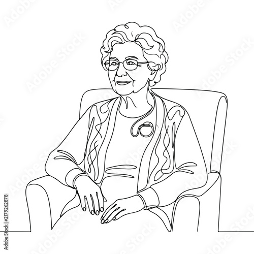 Senior woman with pacemaker sitting comfortably in chair. Older woman includes heart monitor device, round glasses, styled curly hair, and textured cardigan.