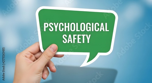 Hand holding a green speech bubble displaying psychological safety message