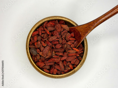Obraz na płótnie Dried Goji Berries in Wooden Bowl With Spoon on White Background, Healthy Superf