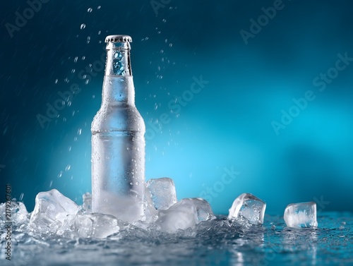 Chilled water bottle surrounded by ice with refreshing blue tones and condensation
