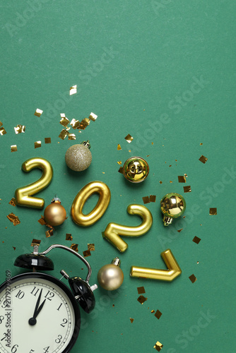 Happy New Year 2027! The holiday season is approaching, featuring twinkling ornaments and festive decor set against a green background—a time for winter celebrations.
