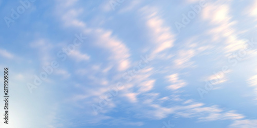 Motion blur effect on a clear blue sky filled with soft white clouds creating a dynamic streaked high-speed movement background