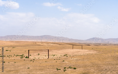 Dry steppe plain with a wire fence near Kamashi, Uzbekistan
