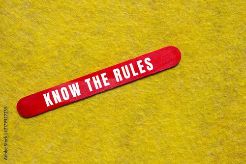 Bild auf Leinwand Red stick displaying white text 'know the rules', symbolizing guidance, policy,