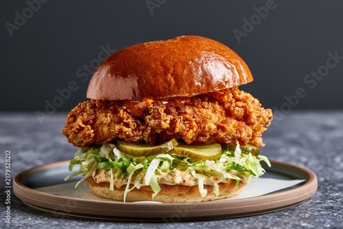 Crispy fried chicken sandwich with shredded lettuce and pickles