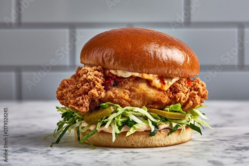 Crispy fried chicken sandwich with fresh lettuce and pickles