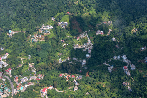 Aerial photography of green hills with scattered houses and hotels