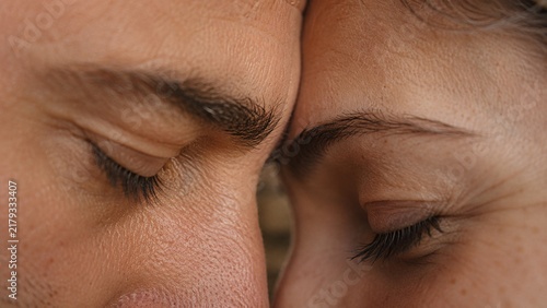Two People Sharing Quiet Intimacy Through Gentle Forehead Contact Closeup