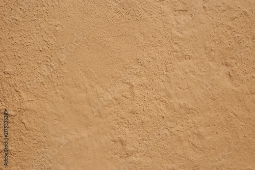 Soil wall texture of clay house structure with sunlight . Mud background. selective focus