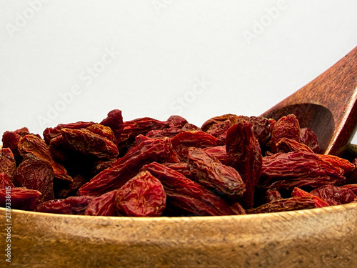 Obraz na płótnie Dried Goji Berries in Wooden Bowl With Spoon on White Background, Healthy Superf