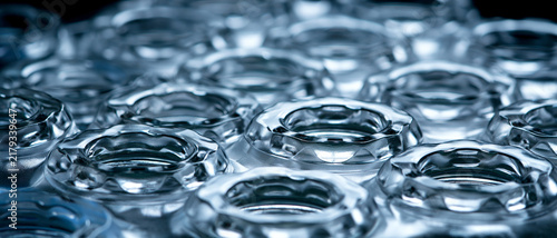 Rows of empty transparent glass bottles in closeup