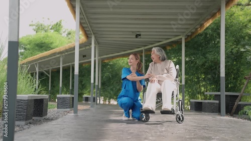 Happy, senior woman and outdoor with caregiver, nurse or healthcare service for person with a disability and wheelchair. Face, smile and elderly lady in park with care or support in retirement