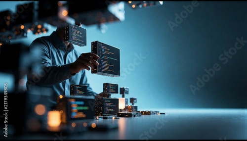 Obraz na płótnie Male software developer interacting with floating digital code modules in a dark high-tech virtual environment.