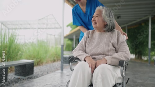 Happy, senior woman and outdoor with caregiver, nurse or healthcare service for person with a disability and wheelchair. Face, smile and elderly lady in park with care or support in retirement