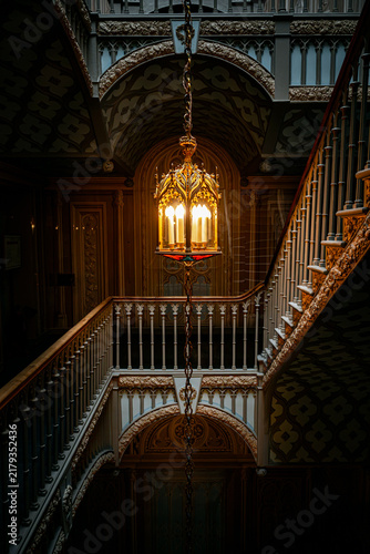 Elegant Vintage Gothic Staircase with Glowing Ornate Lantern.