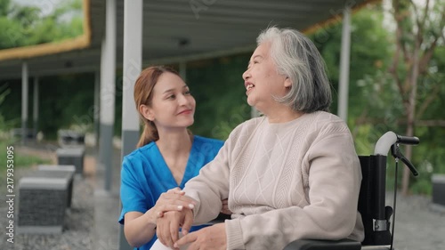 Happy, senior woman and outdoor with caregiver, nurse or healthcare service for person with a disability and wheelchair. Face, smile and elderly lady in park with care or support in retirement