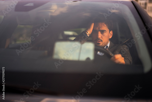 Fotografie Man driving car experiencing stress and worry