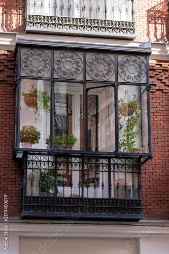 Canvas Print Vintage enclosed glass balcony with green potted plants inside apartment