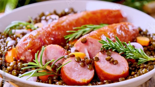 grilled sausages with lentils and fresh rosemary, traditional dish
