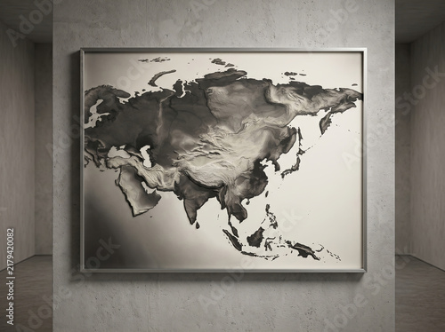 Framed metallic map of Eurasia hanging on a minimalist concrete gallery wall.