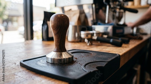Coffee tamper on mat in a modern coffee shop  