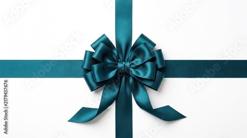 A teal satin ribbon bow crosses over itself, isolated on a plain isolated background, ready for gift wrapping design.