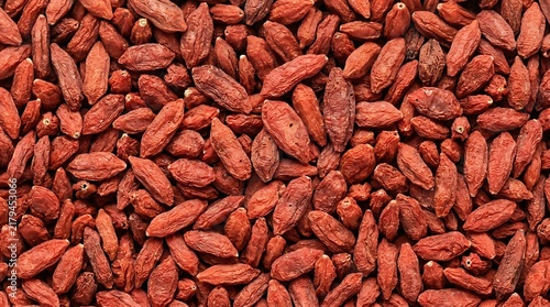 Goji berries top view, a fresh background of dried organic superfood berries flat lay for healthy nutrition.