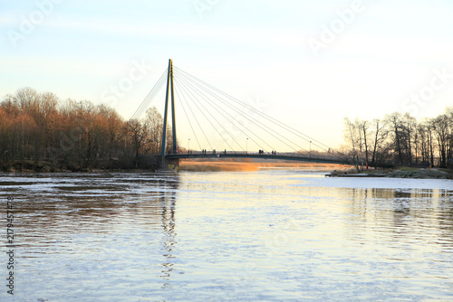 A wintery scene from Helsinki with bridge and icy water.