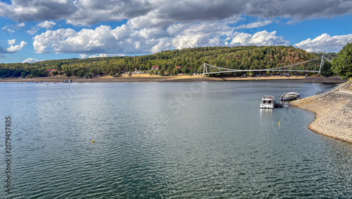 Serene Lake with Lush Green Hills in the Background