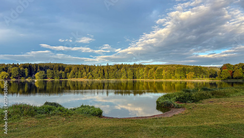 Clouds reflecting on peaceful lake surface view