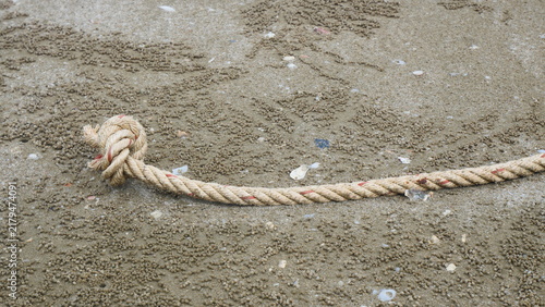 Close-Up of Knotted Rope End on Sandy Beach