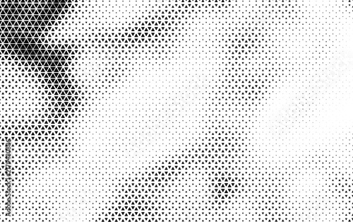 Abstract halftone background with black triangular pattern gradient on white texture
