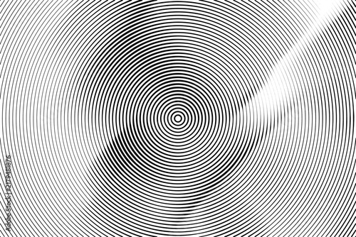 Abstract black and white circular pattern with concentric rings and radial distortion.
