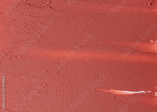Coral lipstick texture background close up