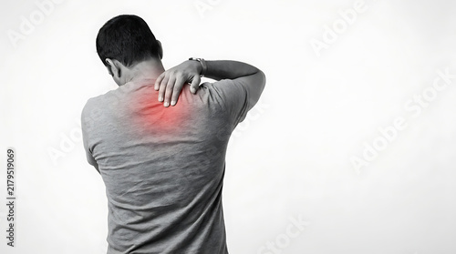 Individual experiencing upper back and neck pain emphasizing discomfort and posture issues
