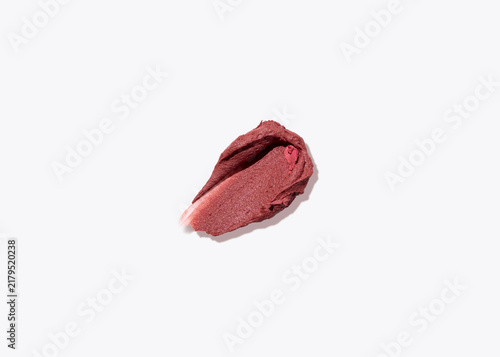 Single lipstick swatch on pale surface