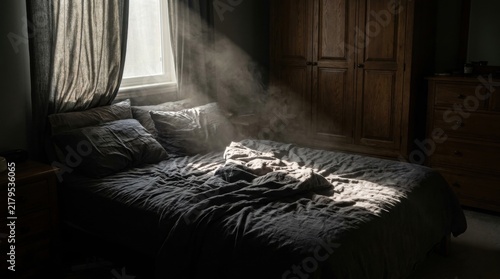 Sunlight streaming through a window onto an unmade bed in a dark moody bedroom, concept of morning peace and solitude