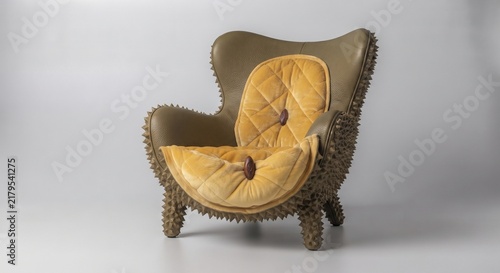 Unique armchair with durian fruit texture and yellow quilted cushion on white background