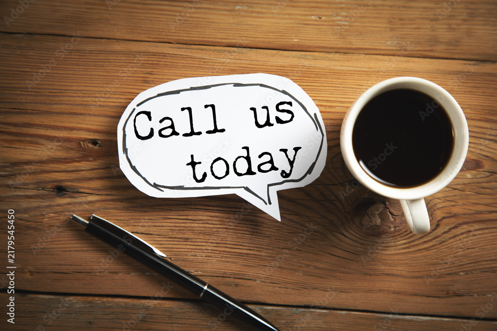 Foto call us today  text on paper