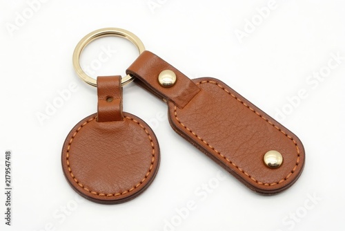 Brown leather key chain with metal ring isolated on white background art.