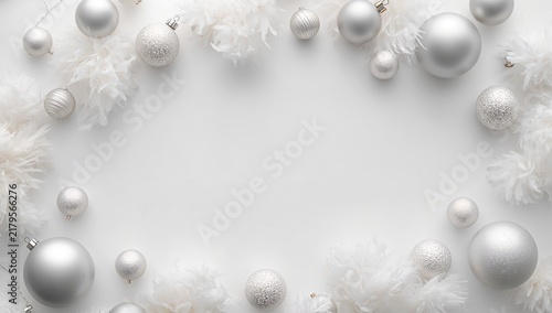 Elegant silver ornaments and soft white feathers arranged in a graceful frame, creating a festive and luxurious atmosphere