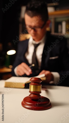 Scales of Justice with Blurred Lawyer Reading Document in Law Office