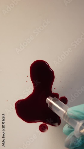 Extracting blood sample with pipette for crime scene forensic and laboratory analysis, top view close up, wide top copy space, vertical video