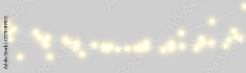Foto Curved strings of glowing yellow light bulbs are suspended against a dark background