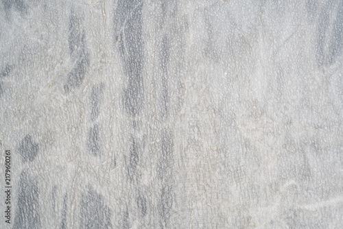 Full frame background texture of light grey and white marble stone surface with natural veins