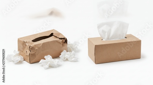 Comparison of a crushed empty tissue box and a new full tissue box isolated on white background