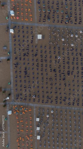 Aerial top down view of empty italian beach umbrellas